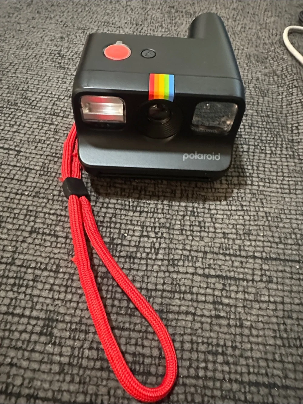 Polaroid Black Instant Camera with Red Strap and Rainbow Accent Polaroid go